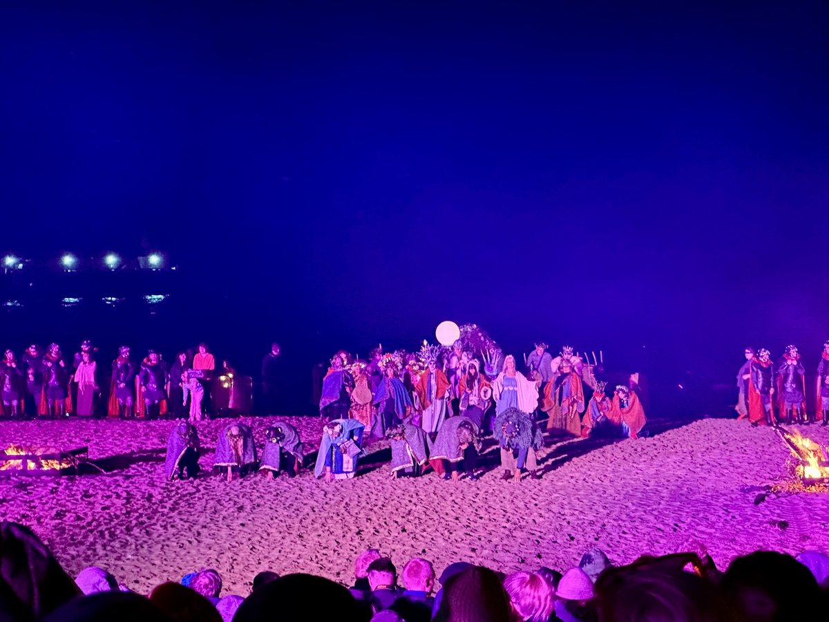 Torch-bearing performers at the fire festival on Peel beach
