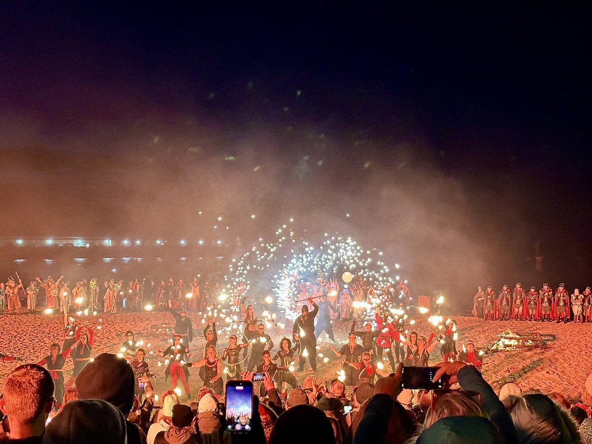 Nighttime fire festival on Peel beach with torches and Viking reenactors
