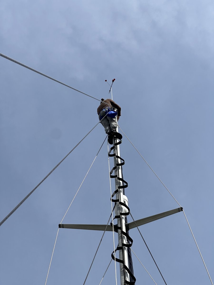 Rob aloft on the mast doing rigging work