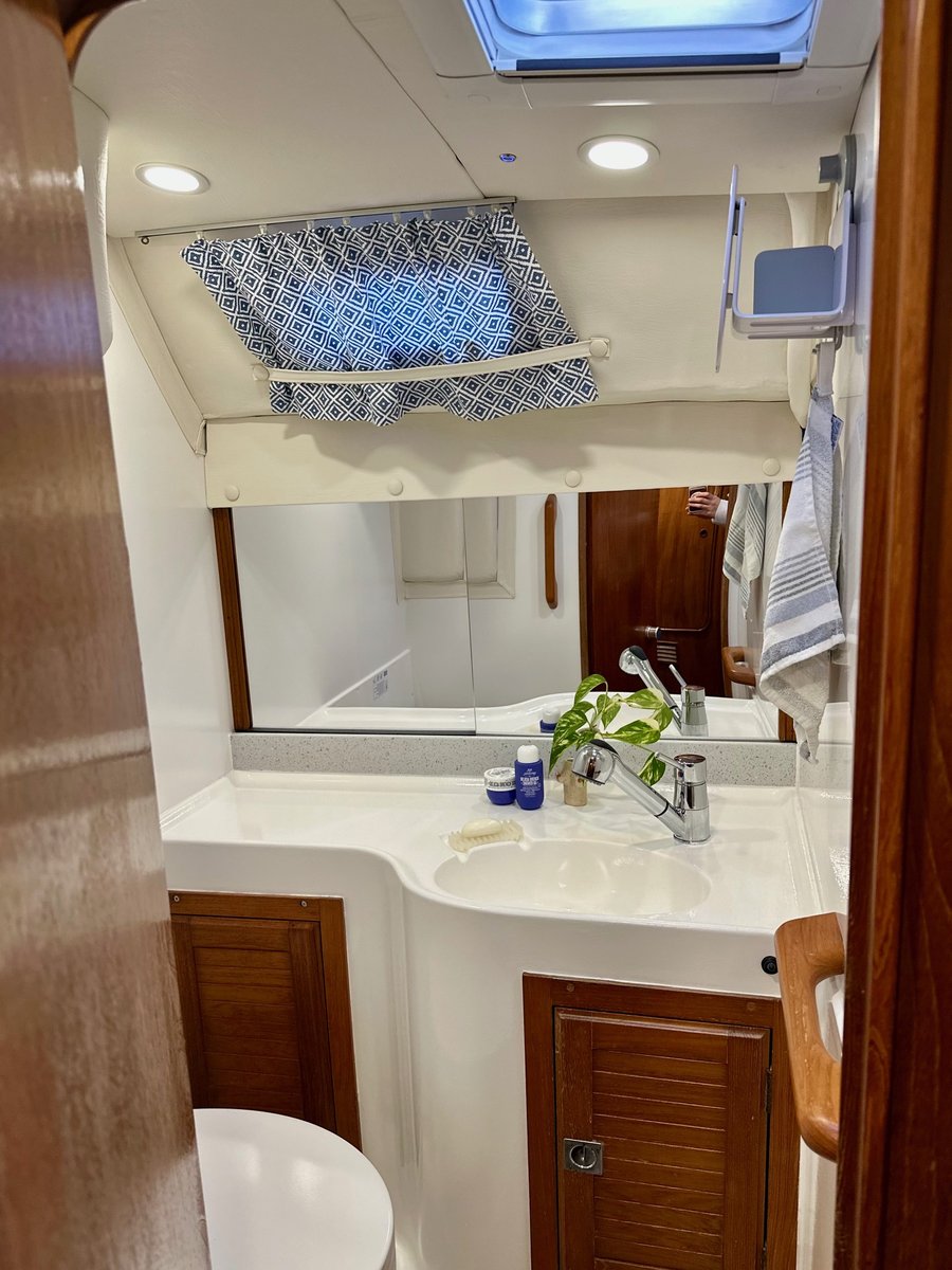 Aft head refurbished with modern fixtures and shower curtain