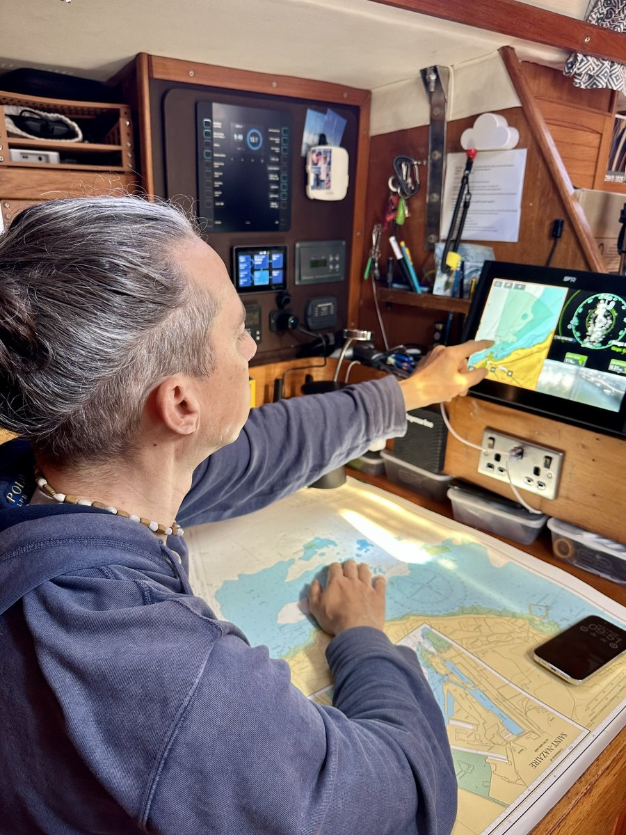 Rob at the chart table - paper and electronic charts for passage planning