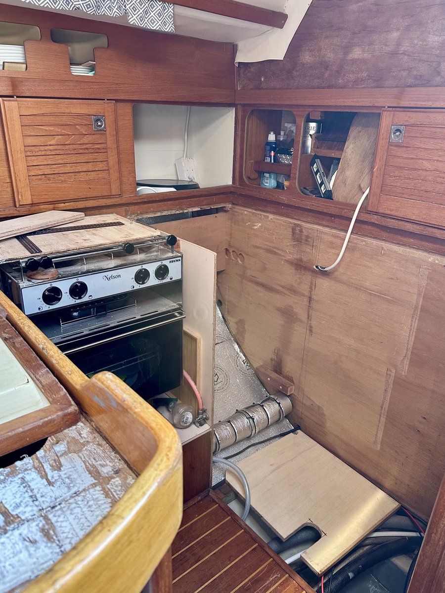 Galley during renovation - stove exposed, insulation and wiring visible