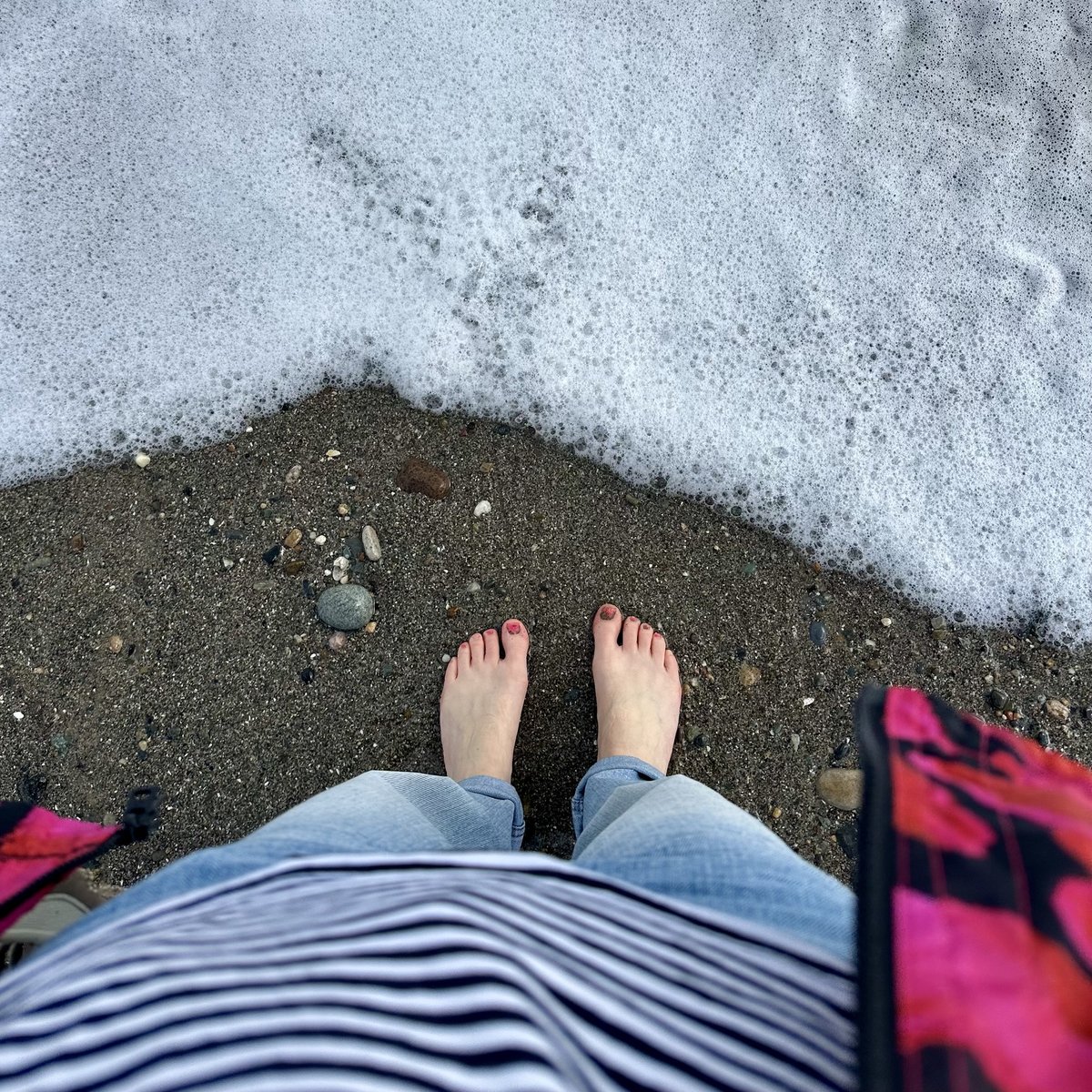 Bare feet on wet sand, waves washing in at South Beach