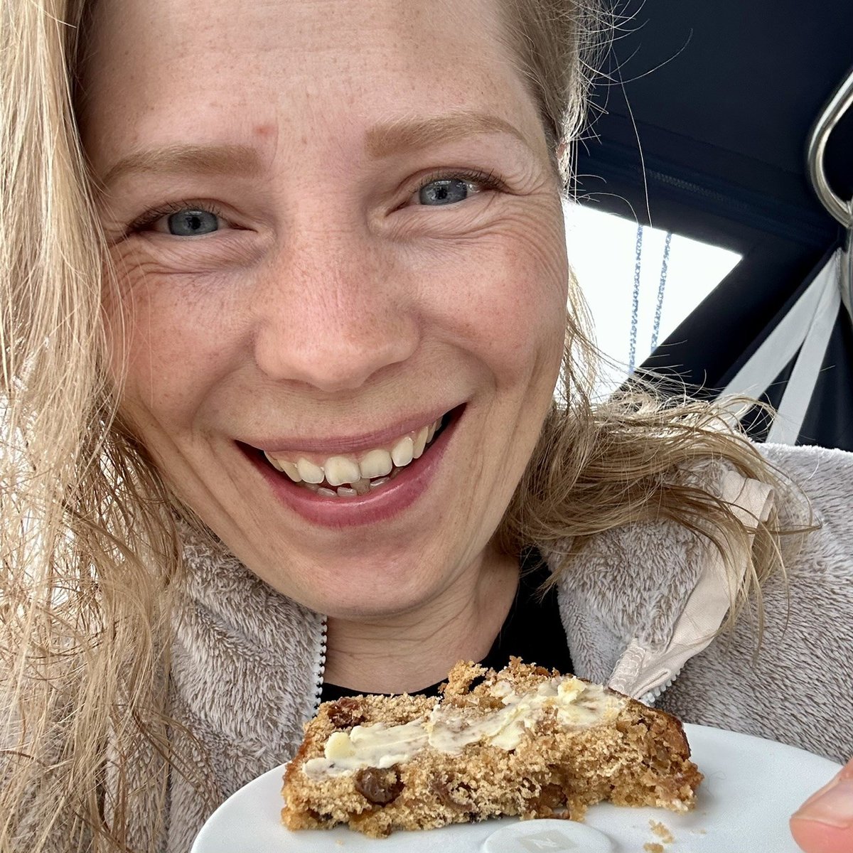 Andrea smiling with bara brith - cake keeps mood high