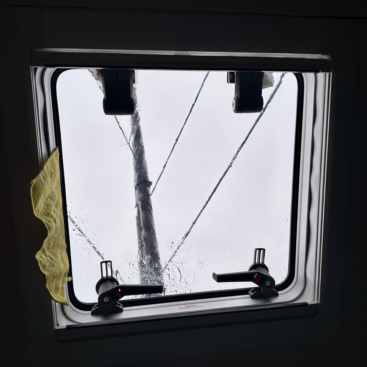 Dripping forward hatch - yellow cloth stuffed to catch the leaks