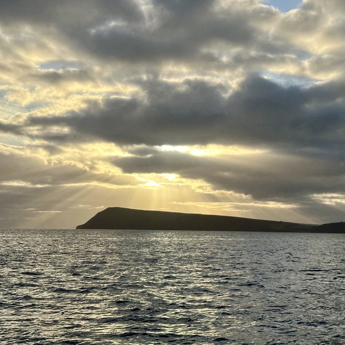 Sunrise leaving Fishguard - golden light breaking through clouds