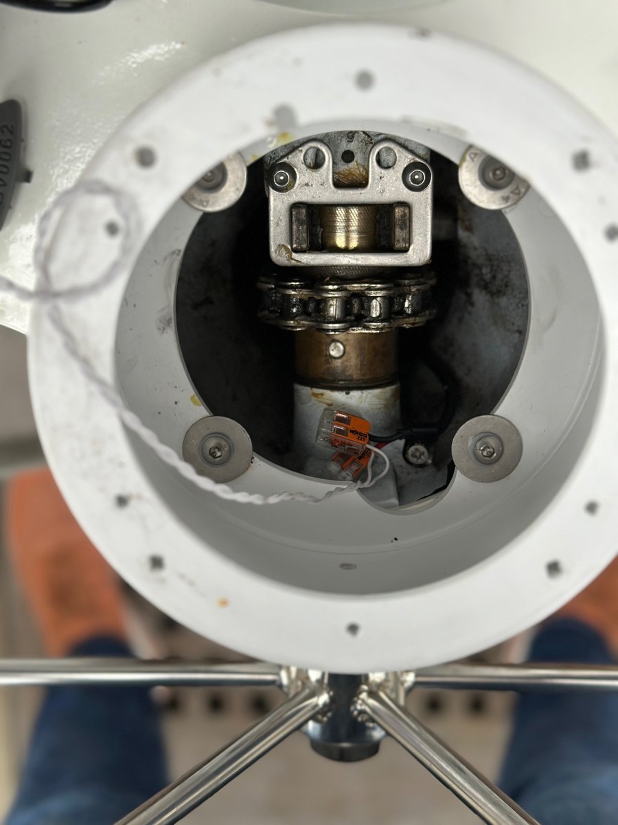 Close-up of steering repair - chain and mechanical housing inside the pedestal