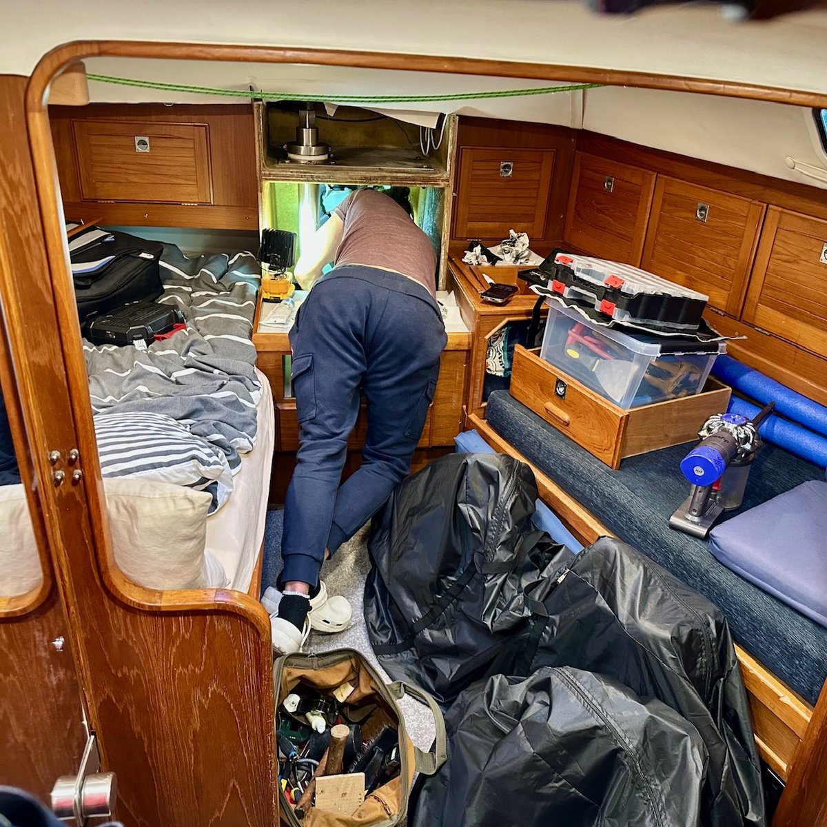 Steering repair down below - Rob working in the aft cabin surrounded by tools