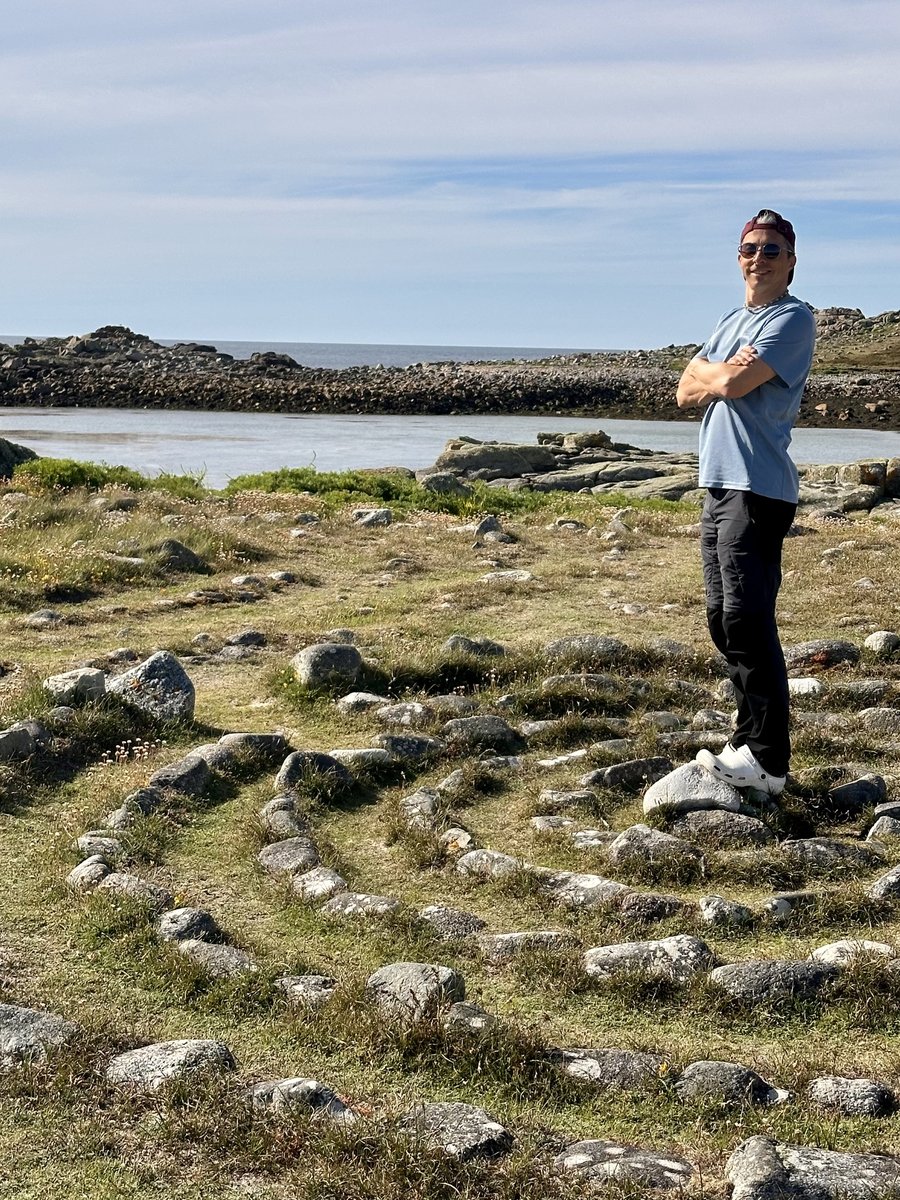 Rob at Hell's Bay stone labyrinth on Bryher, coastal landscape