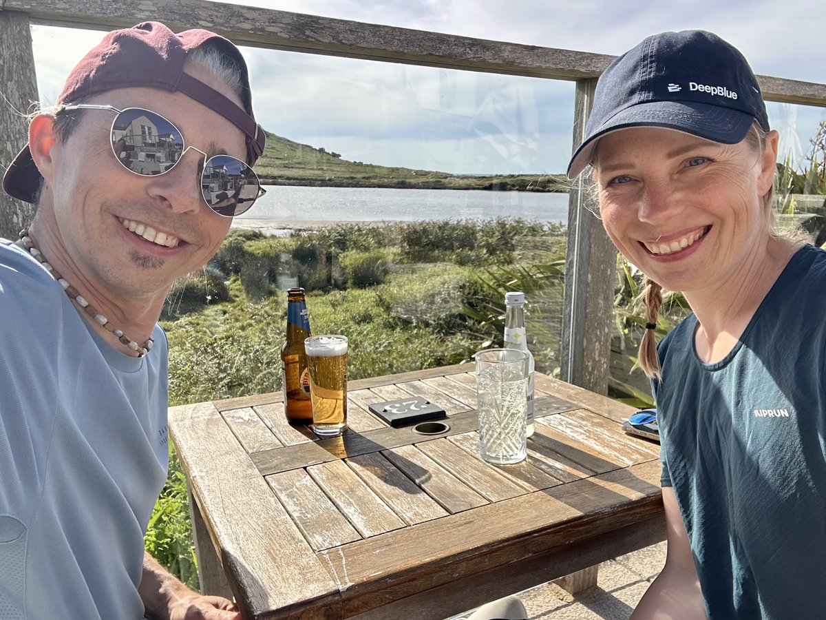 Rob and Andrea at Hell's Bay Hotel with drinks, sea view behind
