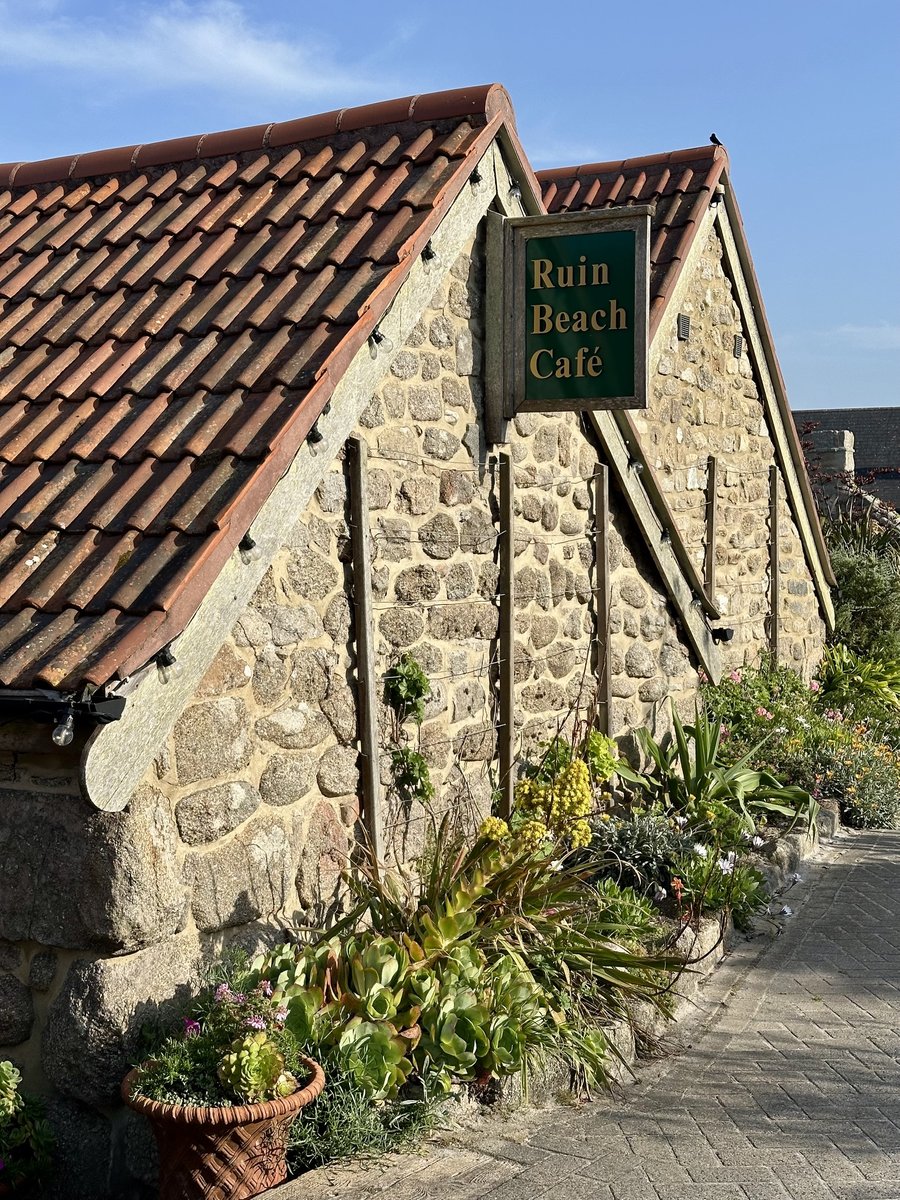 Ruin Beach Cafe exterior - stone building with terracotta roof and garden