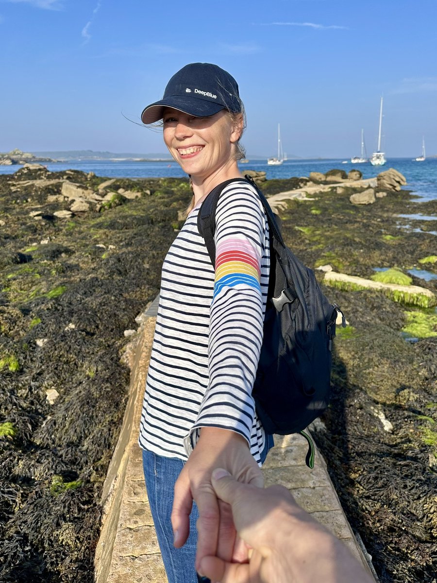 Andrea on the coastal path at Old Grimsby, sailboats in the bay