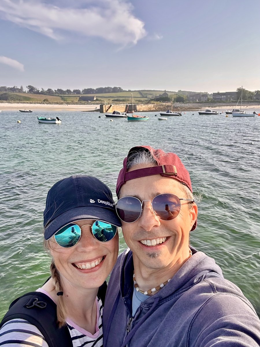 Rob and Andrea at Tresco with sailboats in the bay