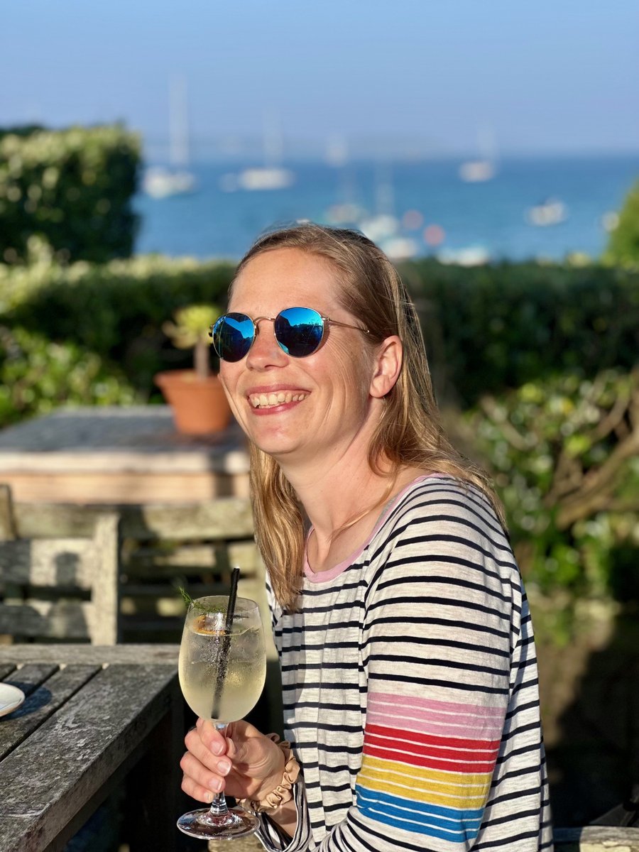 Andrea with a Limoncello Spritz at the Ruins Cafe, sea view behind