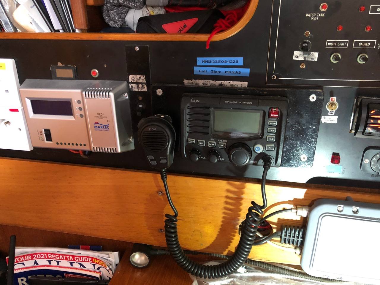 Old panel close-up showing ICOM VHF radio and handwritten call sign labels