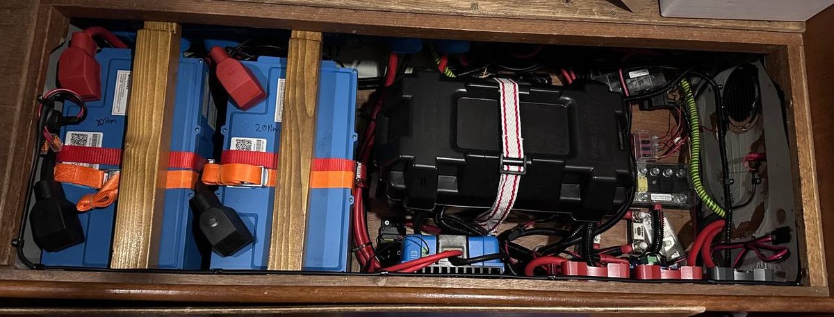 Lithium battery bank - 4 cells in custom compartments with orange securing straps