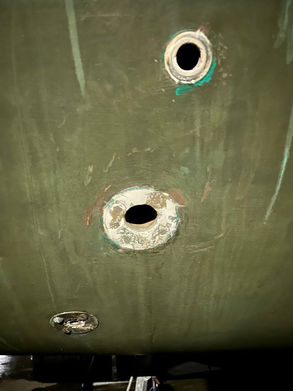 Old through-hull fittings from outside the hull - heavy corrosion and verdigris, a mixture of original bronze and later replacements