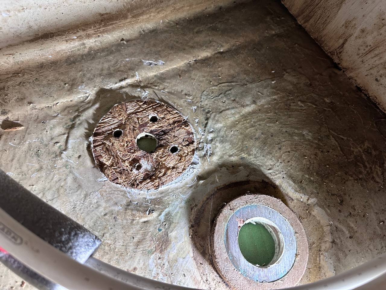 Hull after removing the old through-hull - exposed core material visible through the hole